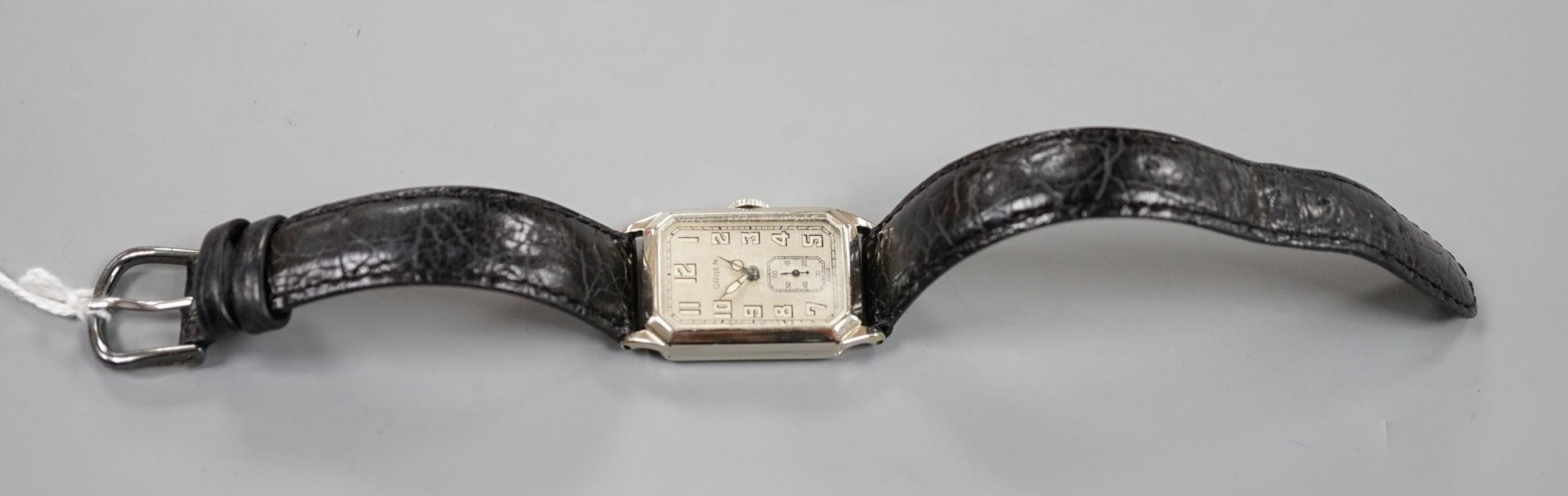 A gentleman's 14k gold filled Gruen manual wind wrist watch, on a leather strap.